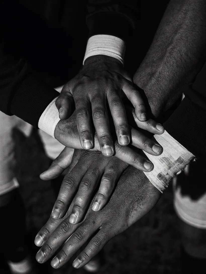 Hands stacked in a team huddle