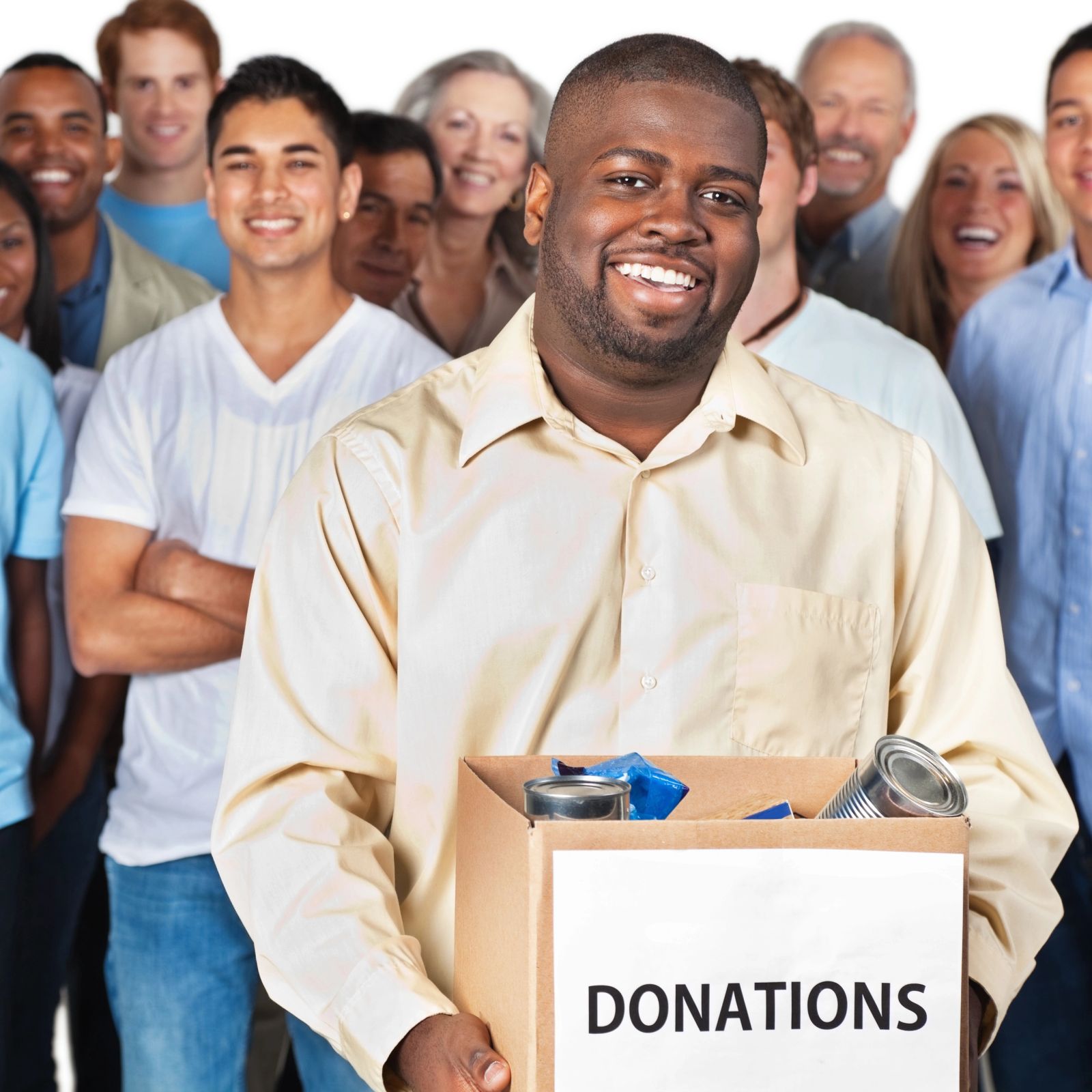 Volunteer holding a box of donated goods in front of a crowd of supporters